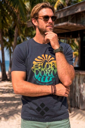 Hombre vistiendo camiseta de algodón azul en playa tropical